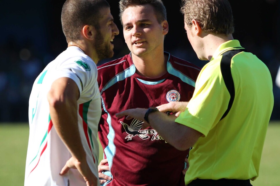 April 06: Ali Haydar of Marconi Stallions argues with referee Kurt Ames  and APIA's Daniel Cummins during round two of the FNSW Premier League match between APIA Leichhardt and Marconi Stallions at Lambert Park (Photo: Damian Briggs)