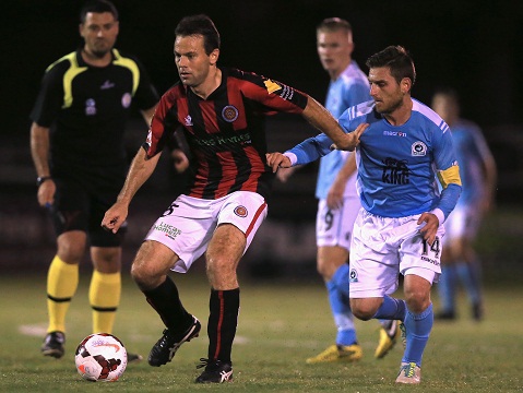 MIRANDA, AUSTRALIA - MAY 10:  T.Reid of the Suns and N.Stavroulakis compete for the ball during the Round 9 IGA NPL NSW Mens 1 match between Sutherland Sharks and Rockdale City Suns at Seymour Shaw Stadium on May 10, 2014 in Miranda, Australia.  (Photo by Jeremy Ng/Football NSW)