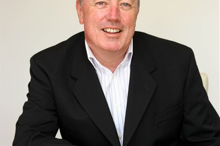 a man wearing a suit and tie sitting at a table