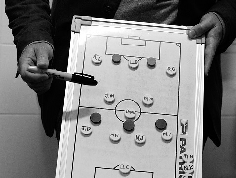 SYDNEY, AUSTRALIA - AUGUST 19:  (EDITORS NOTE: Image has been shot in black and white. Color version not available.) Hakoah Sydney City East coach, Mark Robertson speaks tactics with his players prior to the FFA Cup match against the Palm Beach Sharks at Hensley Athletic Field on August 19, 2014 in Sydney, Australia. Hakoah Sydney City East, founded in 1939 and one of the foundation members of the former National Soccer League, will compete in the inaugural FFA Cup tournament marking its return to a national competition for 27 years.  (Photo by Brendon Thorne/Getty Images)