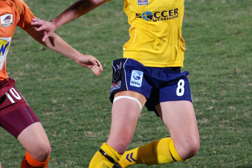 BRISBANE, AUSTRALIA - DECEMBER 20:  Renee Rollason of the Mariners attempts to push away from the Roar defence during the round 9 W-League match between the Queensland Roar and the Central Coast Mariners at Ballymore on December 20, 2008 in Brisbane, Australia.  (Photo by Bradley Kanaris/Getty Images)
