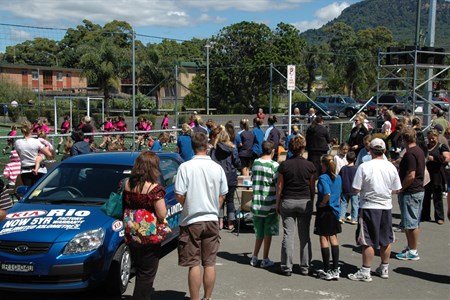 a group of people standing in a parking lot