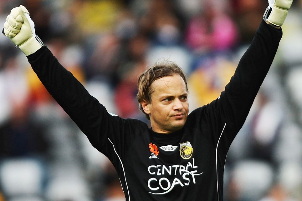 bosnich a man holding his hand up