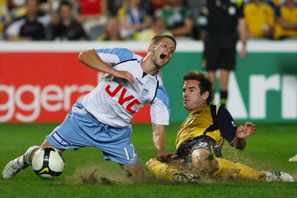 GOSFORD, AUSTRALIA - DECEMBER 13: Shannon Cole of Sydney FC is tackled by Dean Heffernan of the Mariners during the round 15 A-League match between the Central Coast Mariners and Sydney FC at Bluetongue Stadium on December 13, 2008 in Gosford, Australia.  (Photo by Cameron Spencer/Getty Images)