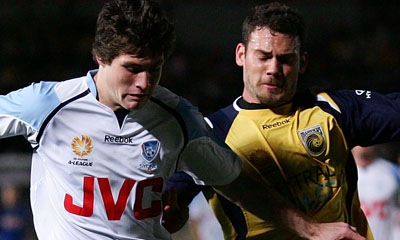 GOSFORD, AUSTRALIA - AUGUST 23:  Predrag Bojic of the Mariners and Chris Payne of Sydney FC compete for the ball during the round two A-League match between the Central Coast Mariners and Sydney FC held at Bluetongue Stadium August 23, 2008 in Gosford , Australia.  (Photo by Matt King/Getty Images)