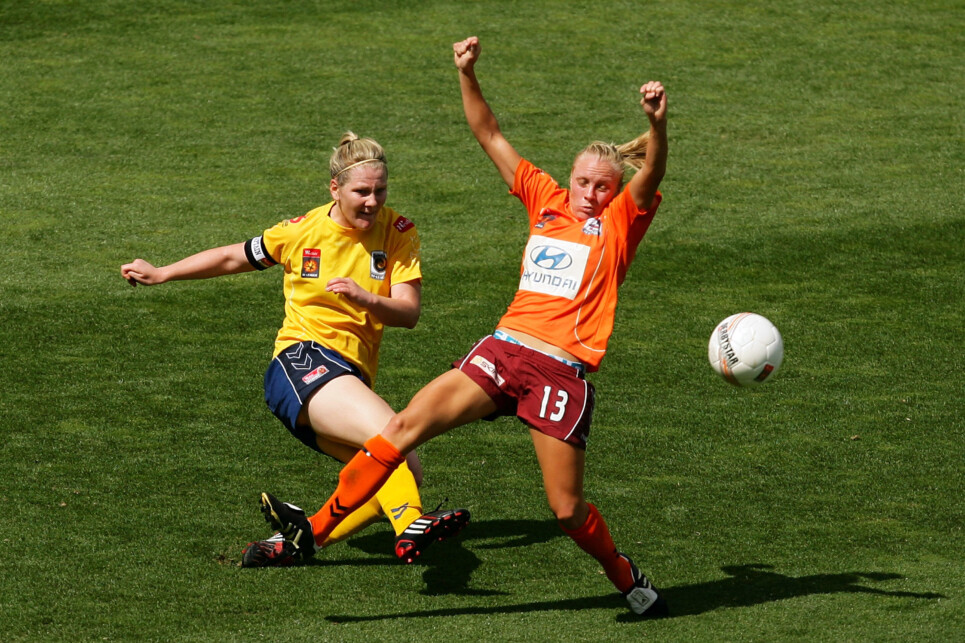 W-League Semi Final - Mariners v Roar GOSFORD, AUSTRALIA - DECEMBER 13: Caitlin Cooper of the Mariners clears the ball in front of Tameka Butt of the Roar during the W-League Semi Final match between the Central Coast Mariners and the Brisbane Roar at Bluetongue Stadium on December 13, 2009 in Gosford, Australia. (Photo by Matt King/Getty Images)