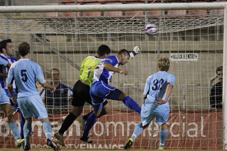a group of people playing football on a field