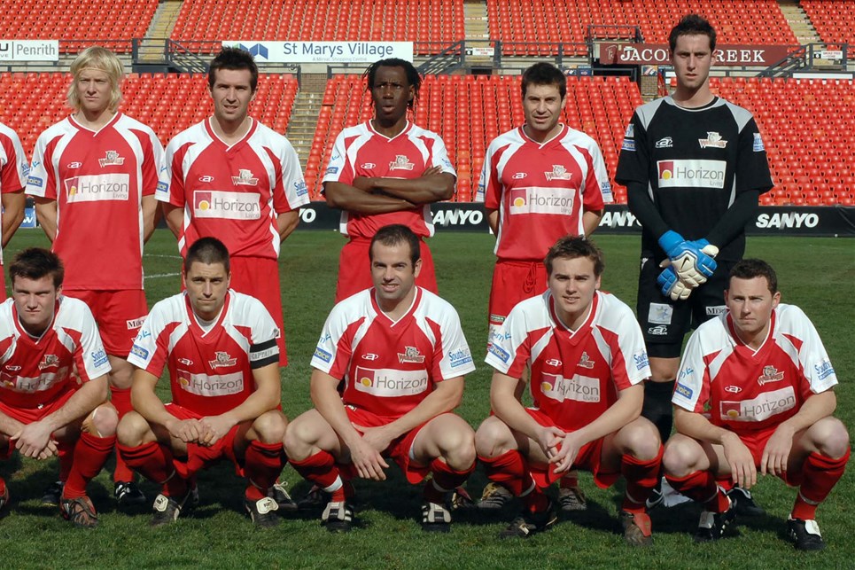 a group of football players posing for a photo