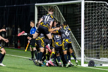 a group of young men playing a game of football