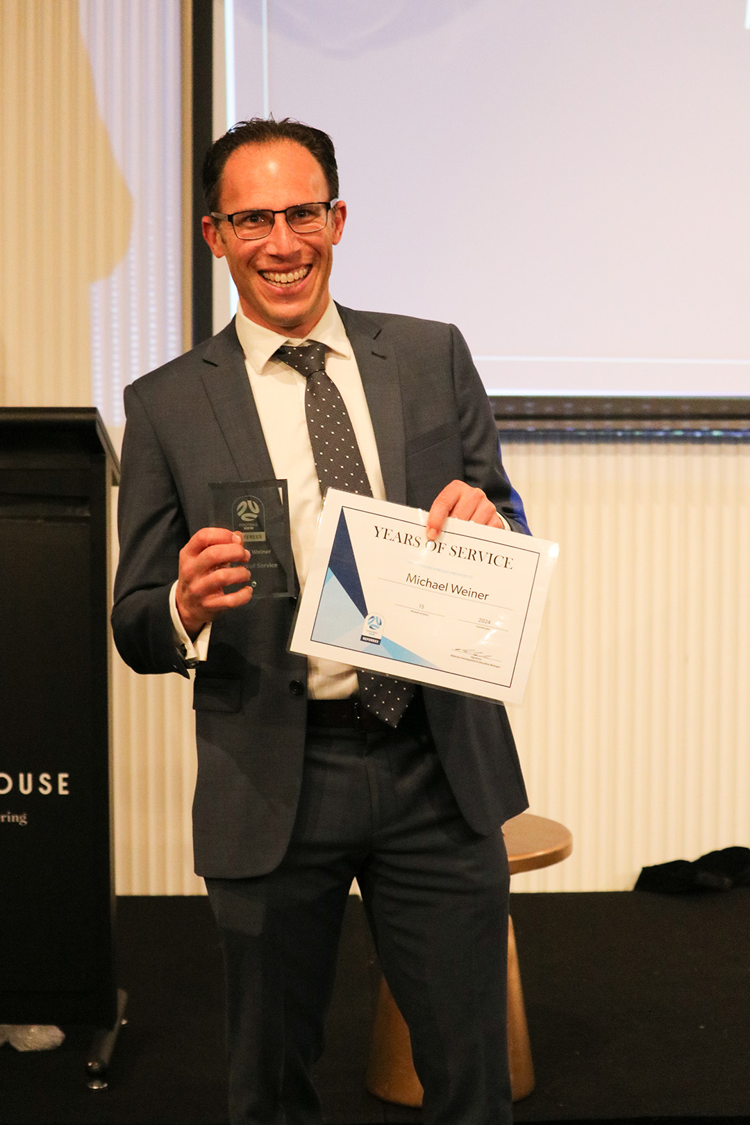 a man wearing a suit and tie reading a book