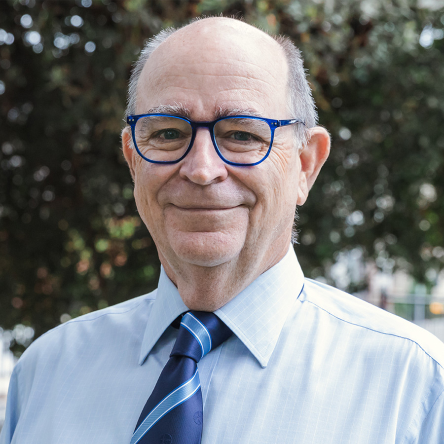 a man wearing glasses and a suit and tie