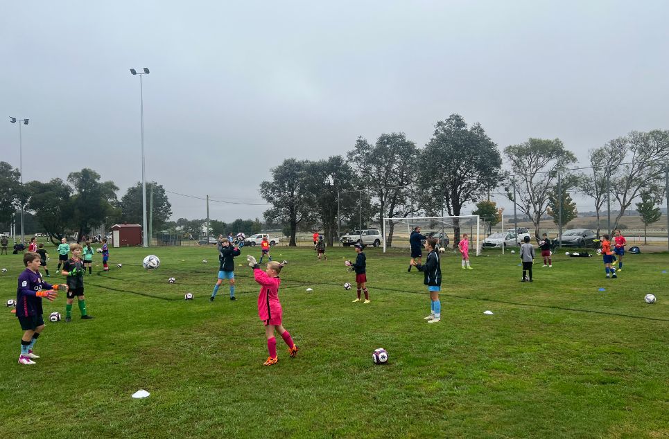 new article banner a group of people playing football on a field