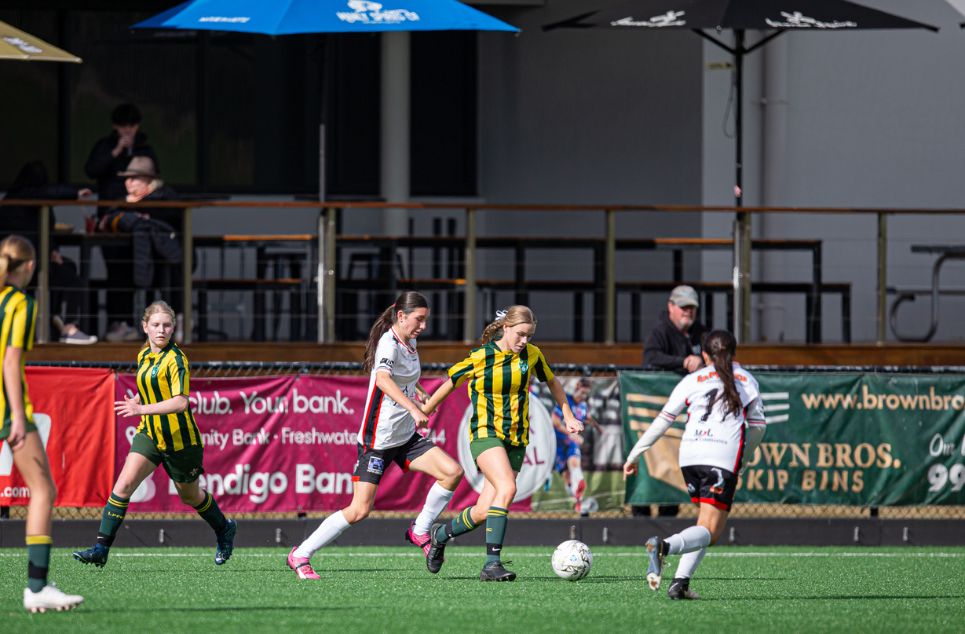 new article banner a group of people playing football on a field