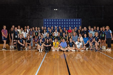 a group of people standing on a basketball court