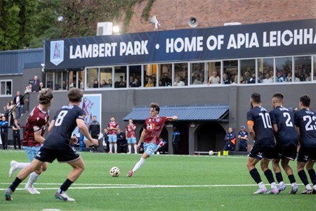 a group of people playing football on a field