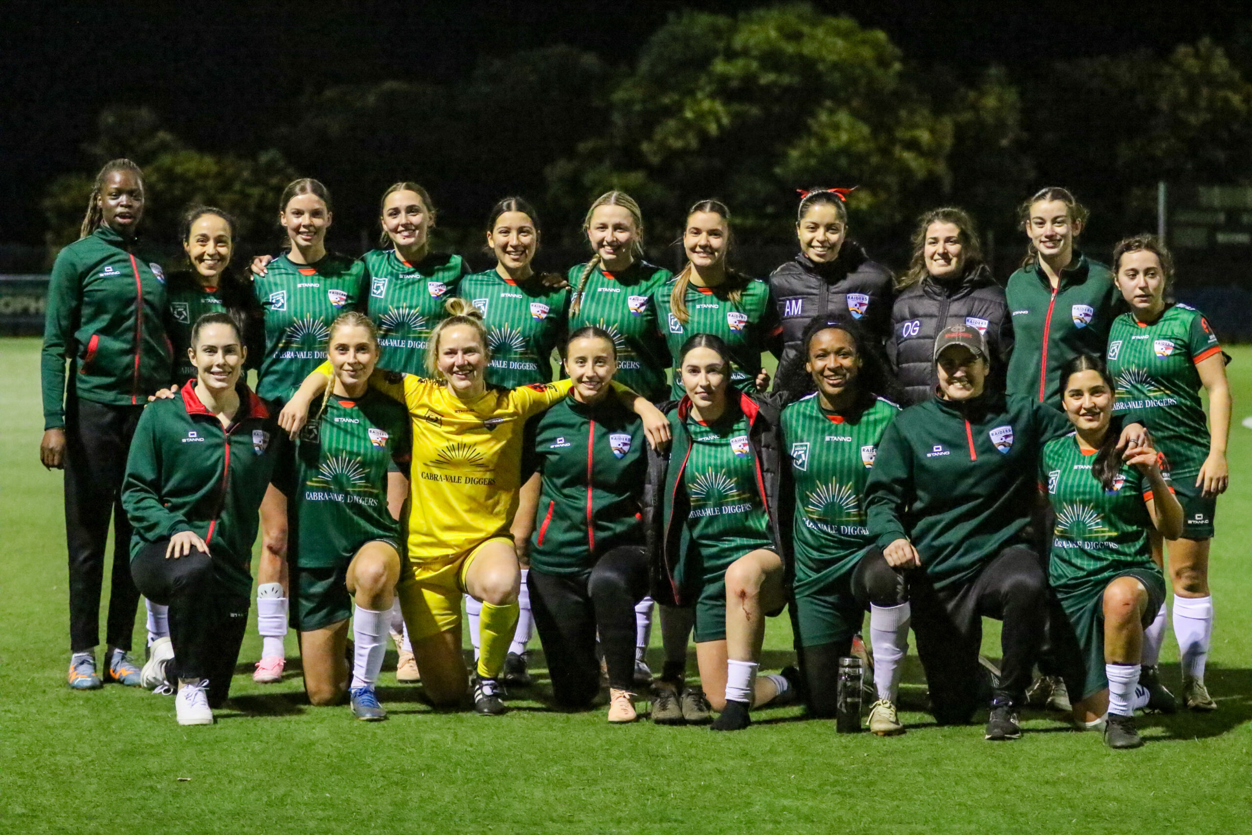 a group of football players posing for a photo