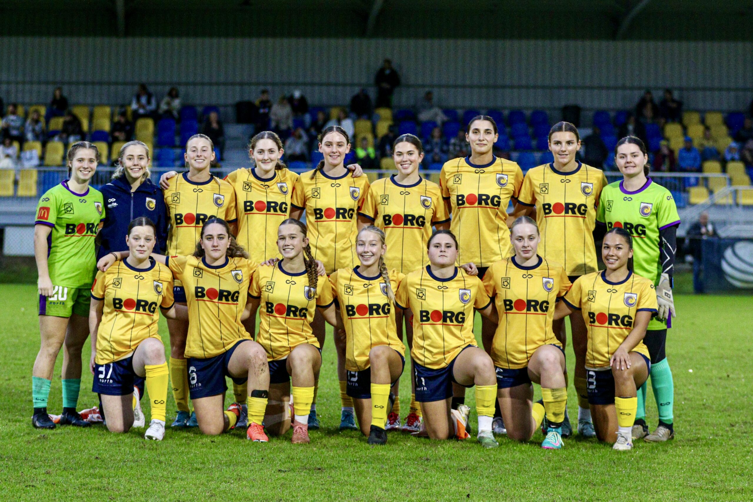 a group of football players posing for a photo