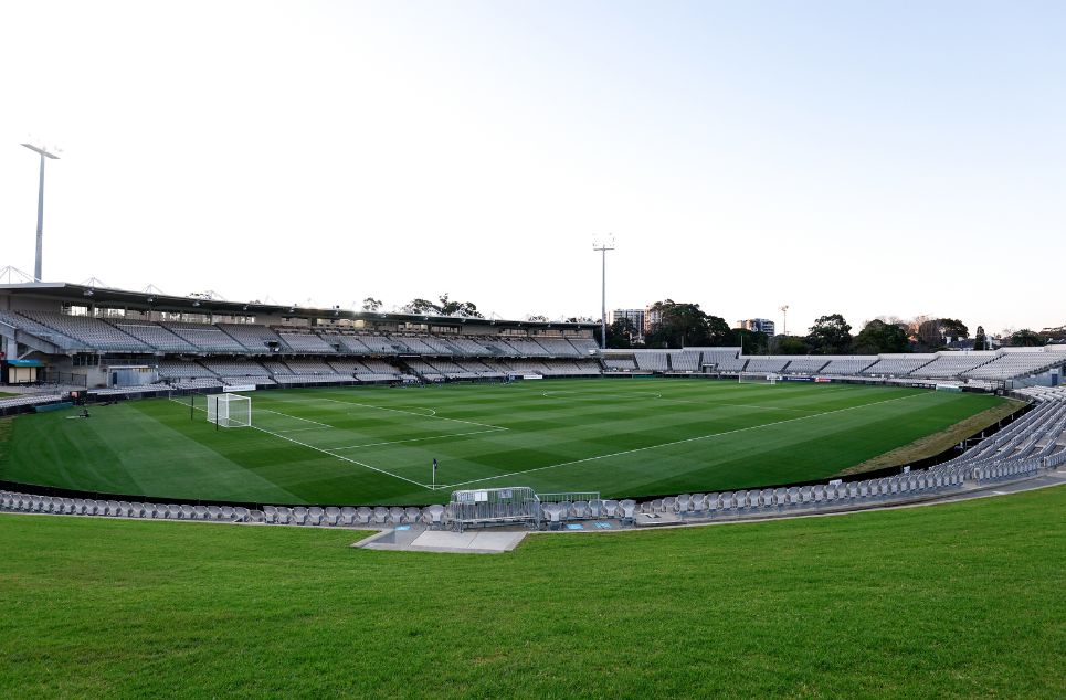 a large stadium with green grass