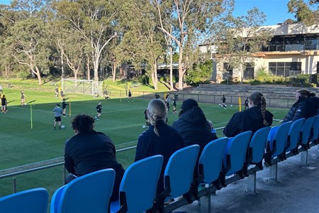 a group of people sitting at a park