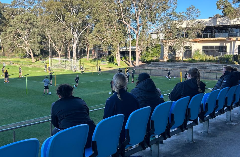 a group of people sitting at a park