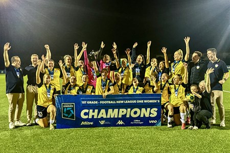 a group of people standing in front of a crowd posing for the camera