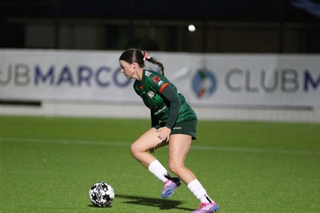 a person holding a football ball on a field