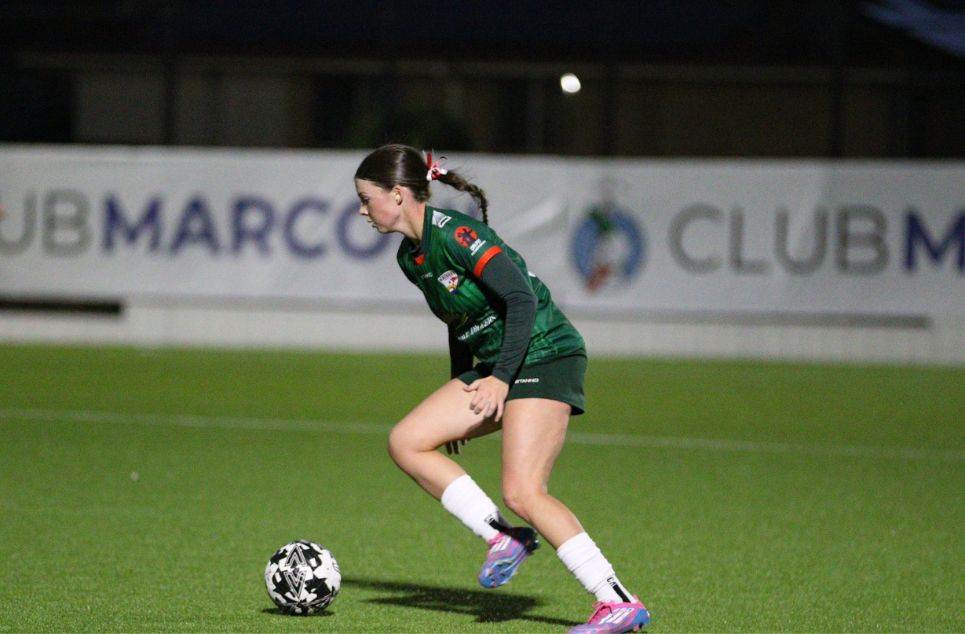 a person holding a football ball on a field