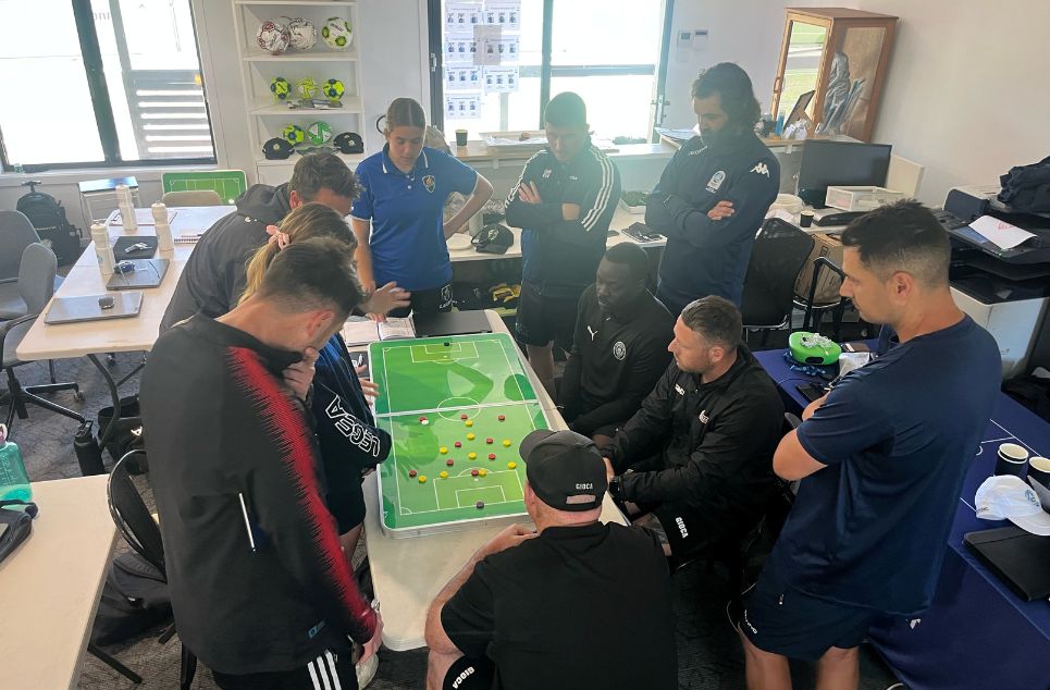 a group of people looking at a computer