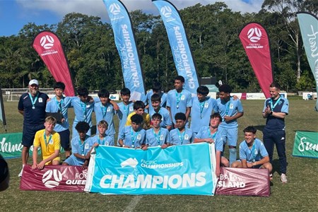 a group of people standing in front of a sign