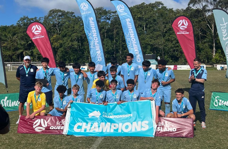 a group of people standing in front of a sign