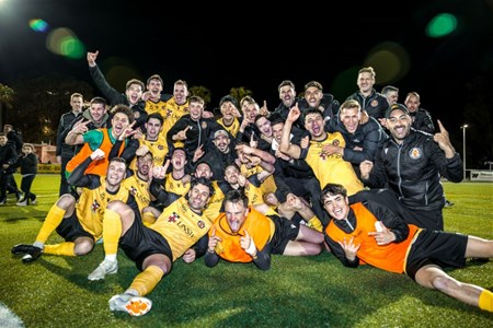 a group of people posing for the football ball