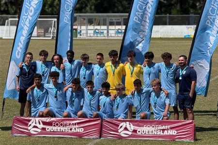 a group of people standing in front of a crowd posing for the camera