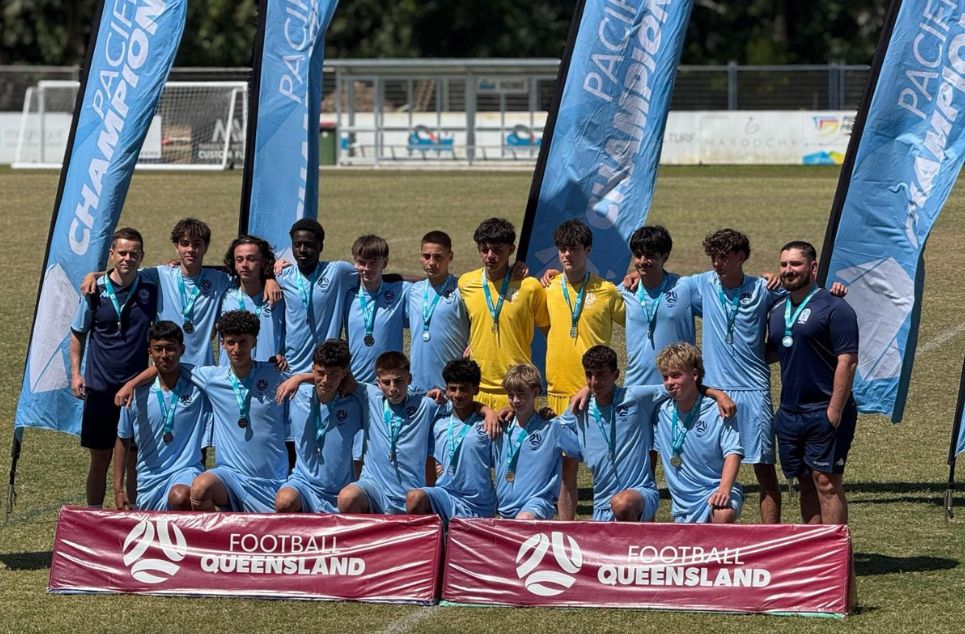 a group of people standing in front of a crowd posing for the camera