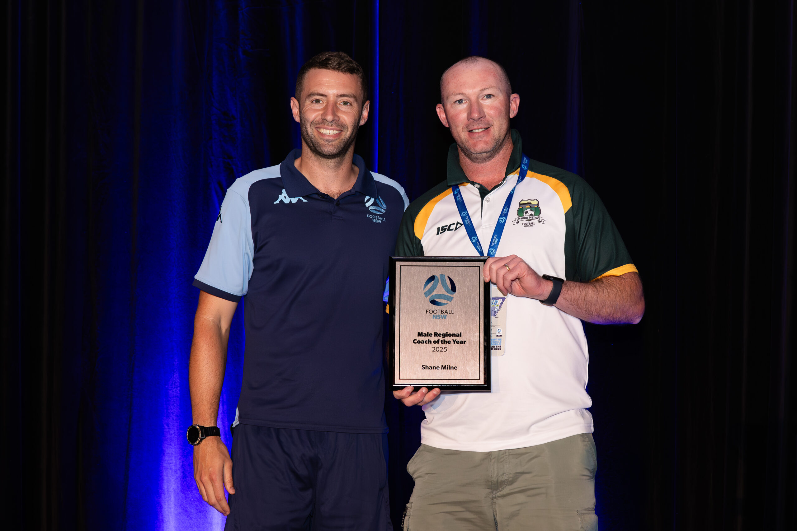 a man standing in front of a curtain