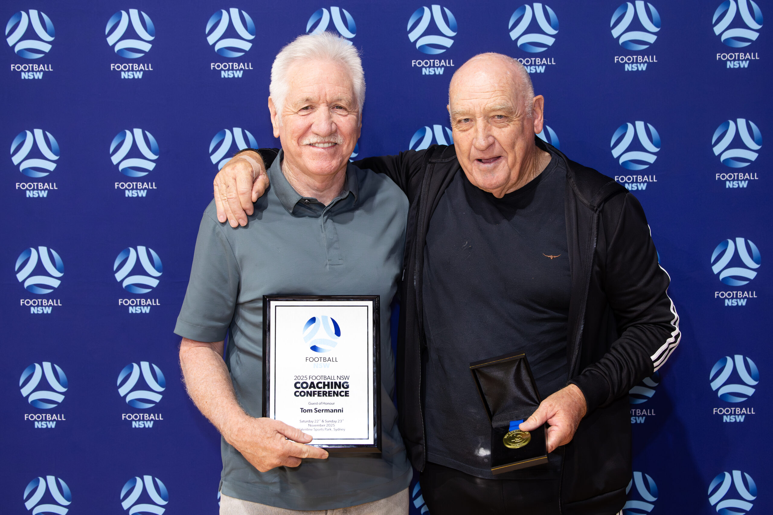 a man holding a sign posing for the camera