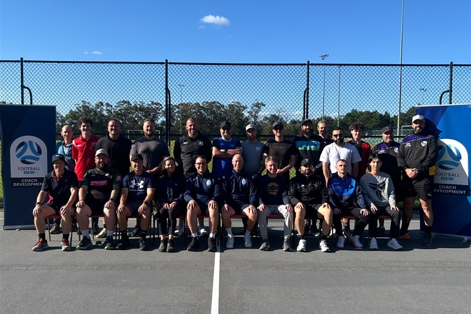a group of people standing in front of a crowd posing for the camera
