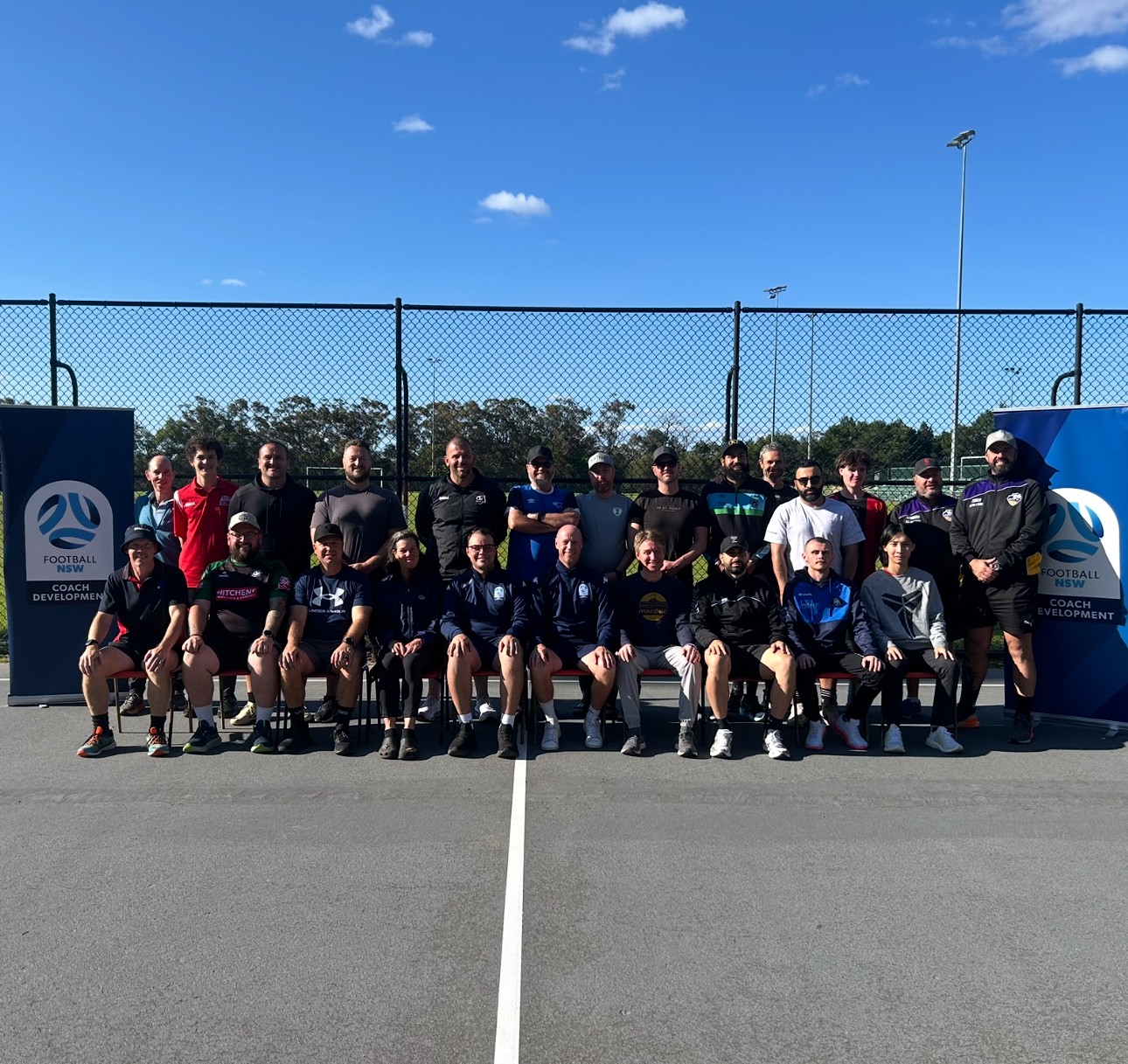 a group of people standing in front of a crowd posing for the camera