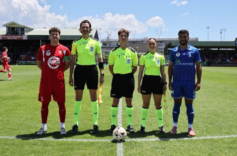 a group of people standing on a football field