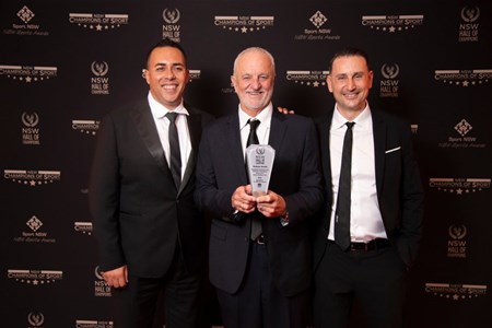 a person standing in front of a group of people posing for the camera