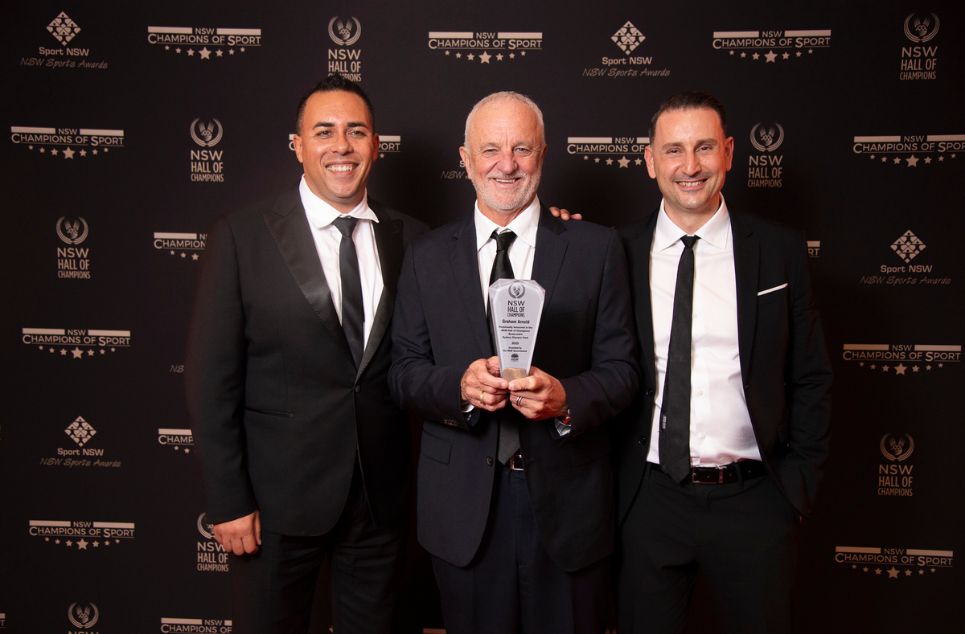 a person standing in front of a group of people posing for the camera