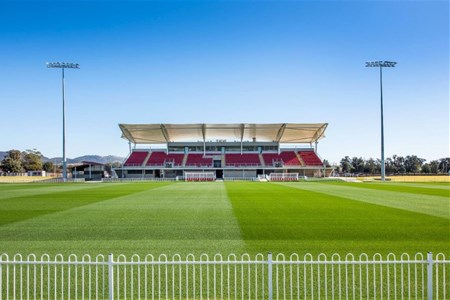 a large stadium with green grass