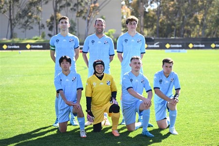 a group of young men playing a game of football