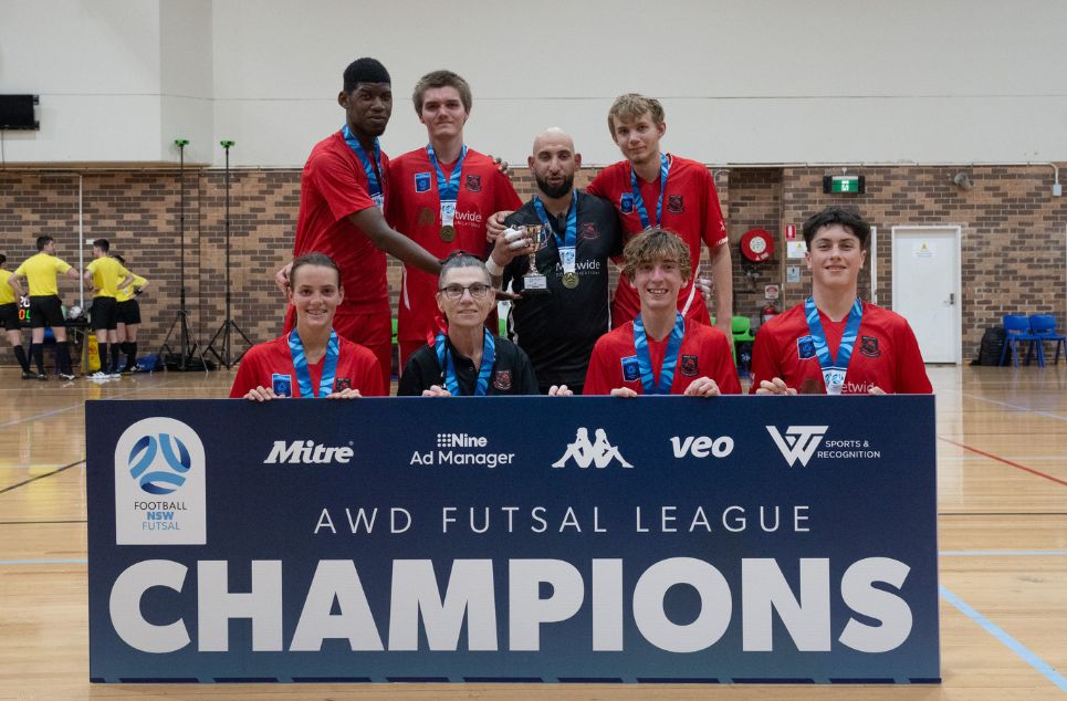 a group of people standing in front of a sign