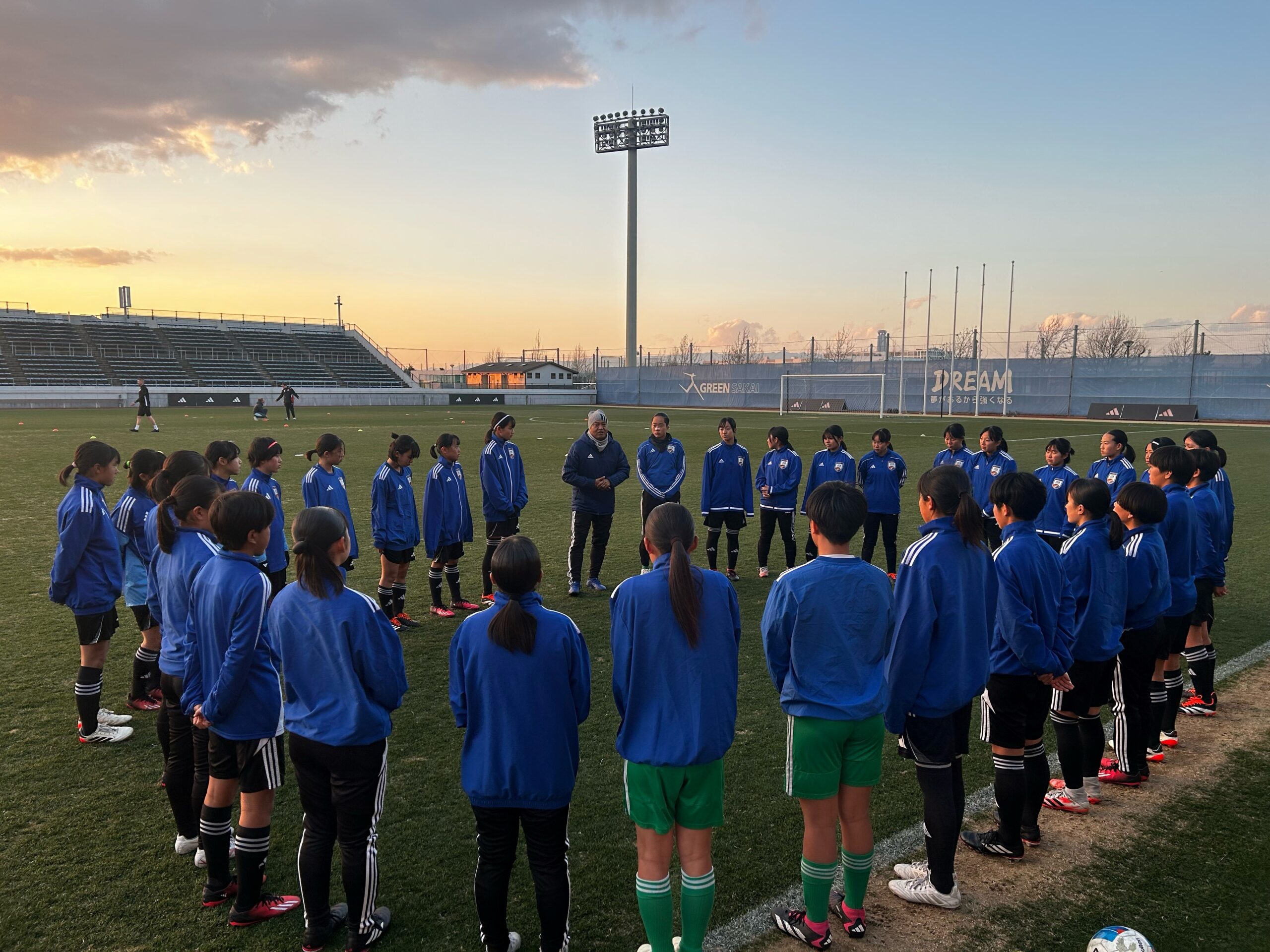 a group of people standing in front of a crowd posing for the camera