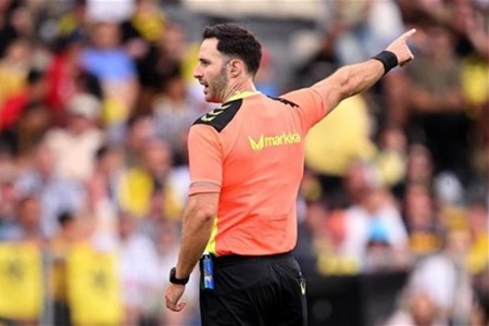 a man holding a football ball in front of a crowd