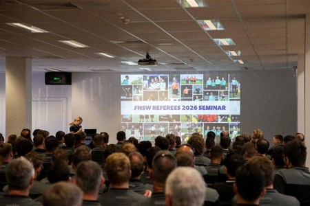 a group of people standing in front of a large crowd of people