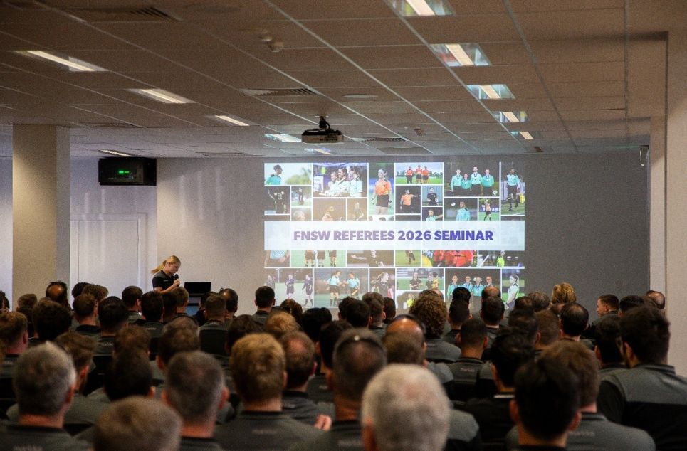 a group of people standing in front of a large crowd of people