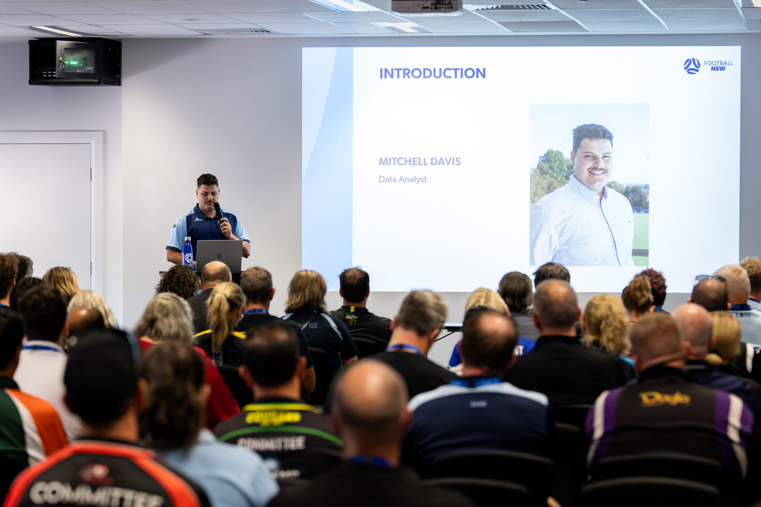 a group of people standing in front of a crowd
