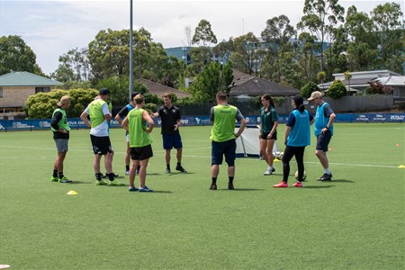 a group of people playing football on a field