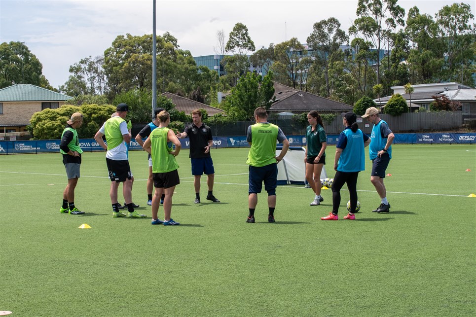 a group of people playing football on a field